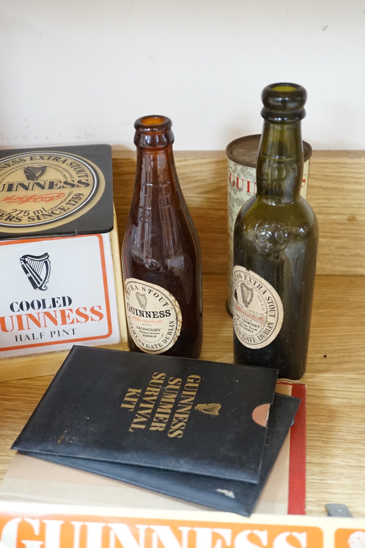 A large quantity Guinness advertising material, including a table lamp with Guinness shade, signage, bar mats, camera etc